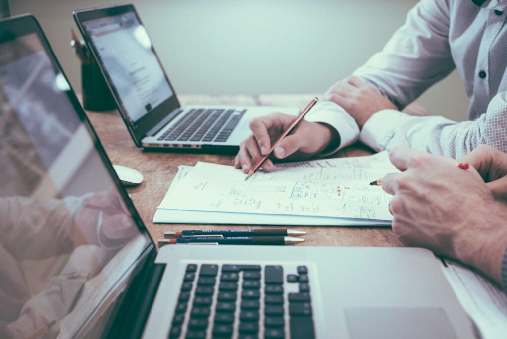Professionals reviewing documents and planning work at a table